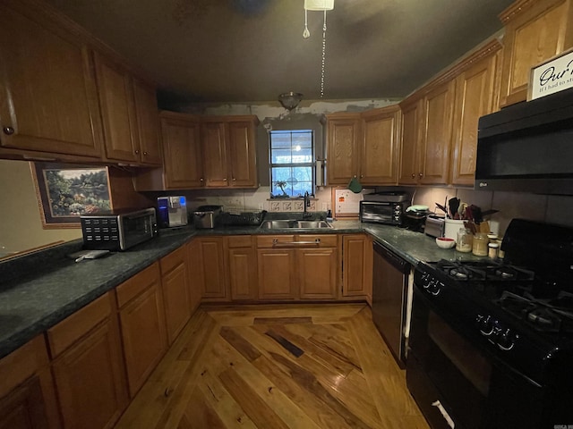 kitchen featuring stainless steel appliances, light parquet floors, and sink