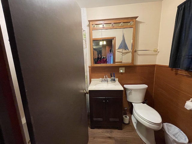 bathroom with hardwood / wood-style floors, vanity, and toilet