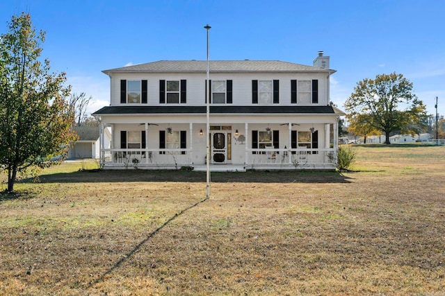 view of front of home with covered porch and a front yard