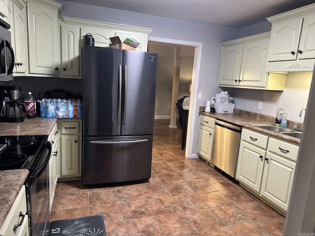 kitchen featuring cream cabinetry, appliances with stainless steel finishes, and sink