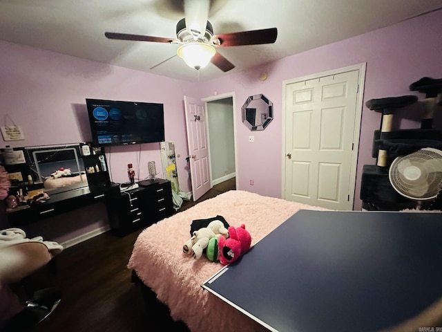 bedroom with dark hardwood / wood-style floors and ceiling fan