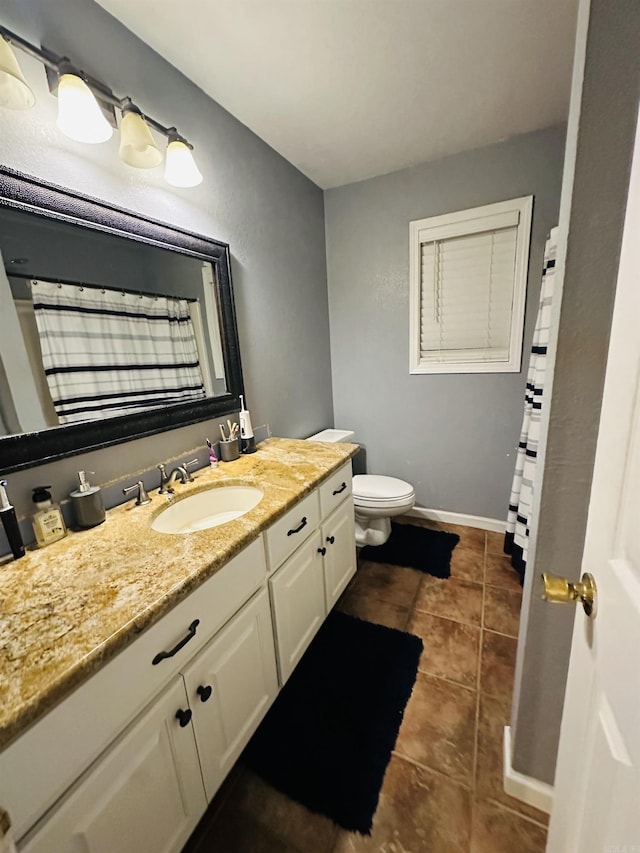 bathroom featuring tile patterned flooring, vanity, and toilet