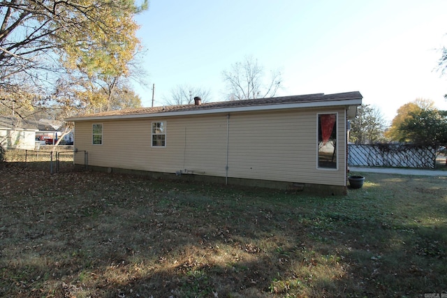 rear view of house with a lawn