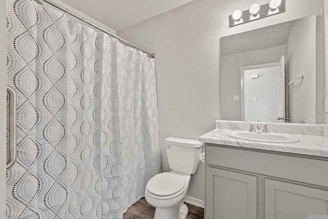 bathroom with a shower with curtain, vanity, toilet, and wood-type flooring