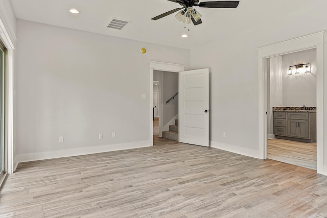 unfurnished bedroom with ensuite bath, ceiling fan, sink, and light hardwood / wood-style floors