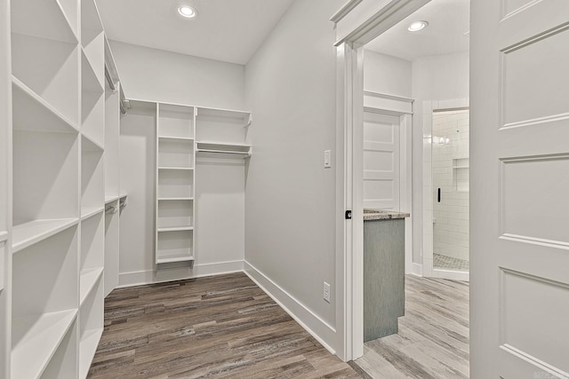 walk in closet with hardwood / wood-style floors