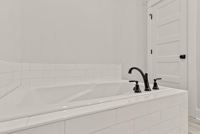 bathroom with a relaxing tiled tub