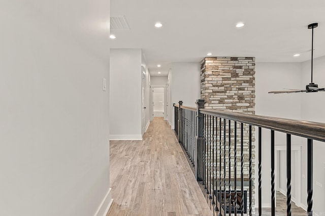 corridor with light hardwood / wood-style floors