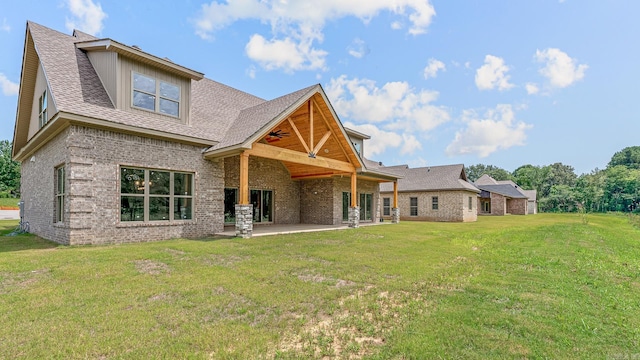 back of property featuring a patio area and a lawn