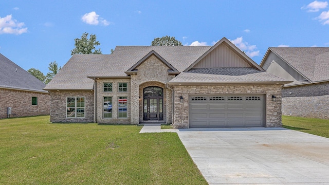 view of front of house with a garage and a front lawn