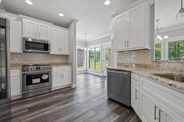 kitchen with white cabinets, a healthy amount of sunlight, and stainless steel appliances