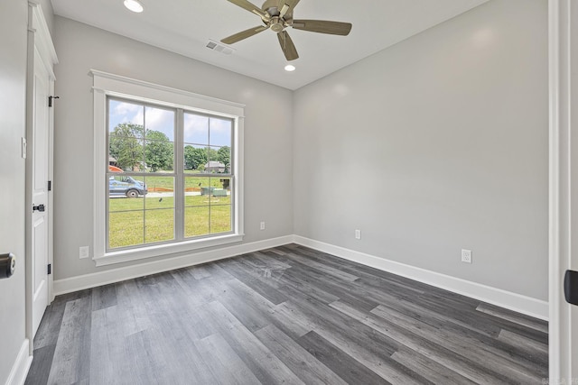 spare room featuring dark hardwood / wood-style flooring, a wealth of natural light, and ceiling fan