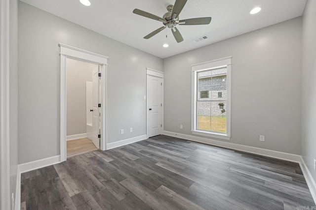 unfurnished bedroom featuring connected bathroom, ceiling fan, and dark hardwood / wood-style flooring