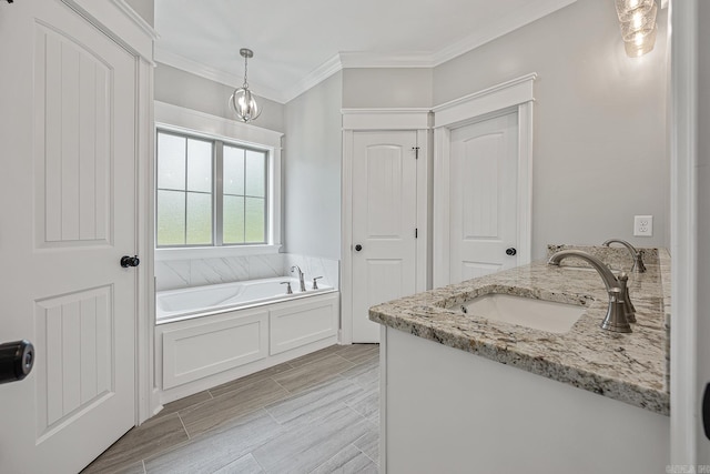 bathroom featuring hardwood / wood-style floors, vanity, crown molding, and a tub