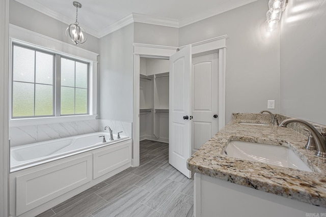 bathroom featuring vanity, crown molding, a healthy amount of sunlight, and a notable chandelier