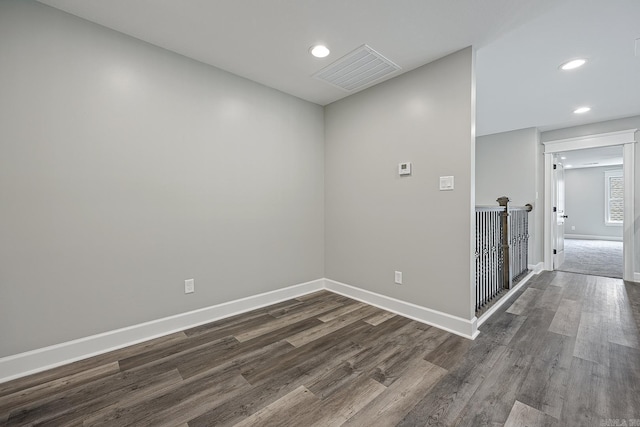 empty room with dark hardwood / wood-style flooring