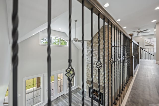 stairs featuring hardwood / wood-style floors, french doors, lofted ceiling, and ceiling fan