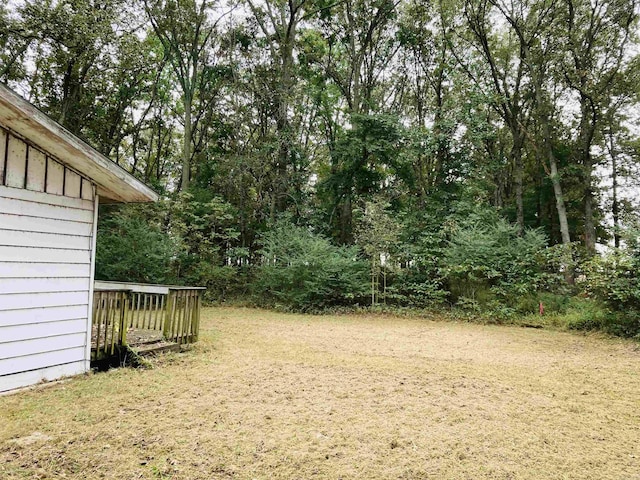 view of yard featuring a wooden deck