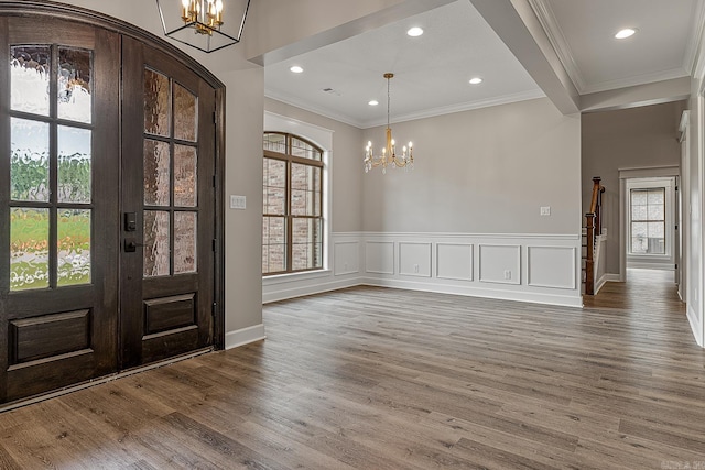 entryway with french doors, wood-type flooring, and a notable chandelier