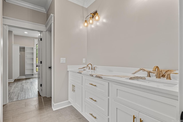 bathroom featuring vanity, wood-type flooring, and ornamental molding