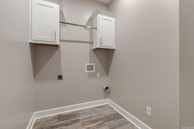 laundry room featuring electric dryer hookup, hookup for a washing machine, cabinets, and dark hardwood / wood-style floors