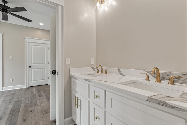 bathroom featuring ceiling fan, vanity, and wood-type flooring