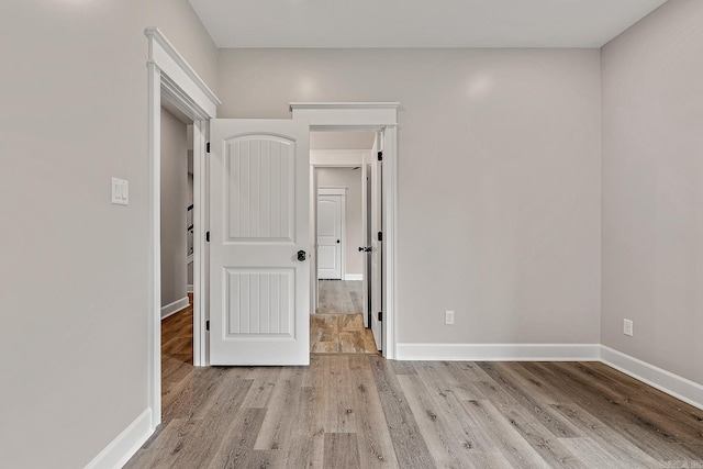 empty room with light hardwood / wood-style flooring