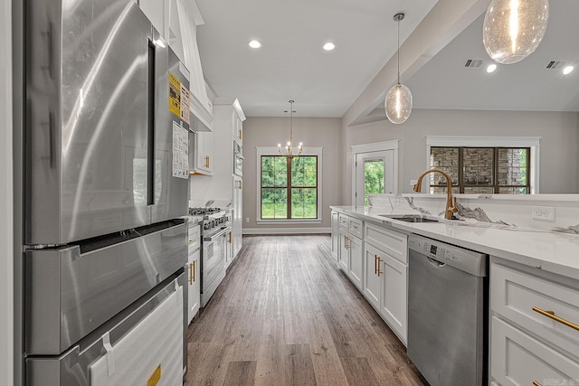 kitchen featuring white cabinets, appliances with stainless steel finishes, and a healthy amount of sunlight