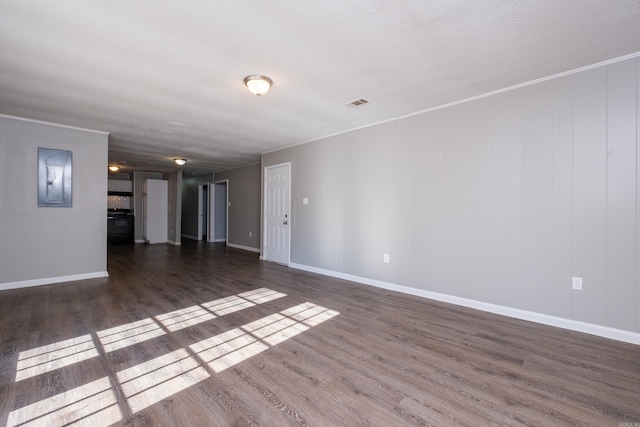 unfurnished living room featuring a textured ceiling, electric panel, and dark hardwood / wood-style floors