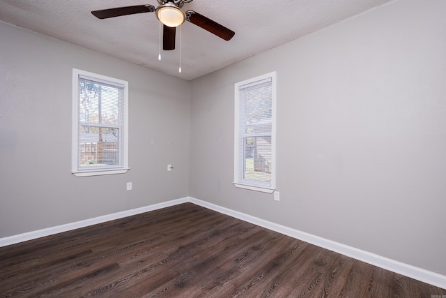 unfurnished room with a textured ceiling, ceiling fan, and dark wood-type flooring