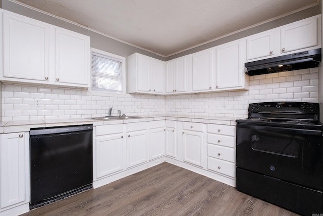 kitchen featuring white cabinetry, dark wood-type flooring, and black appliances