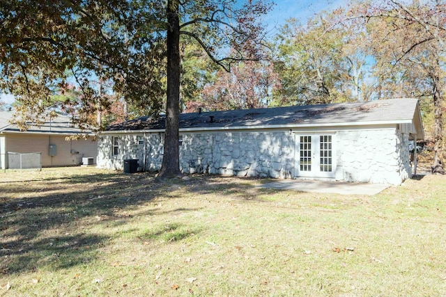 rear view of house with a yard, a patio area, french doors, and central AC unit