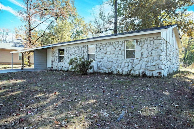 ranch-style house featuring a carport