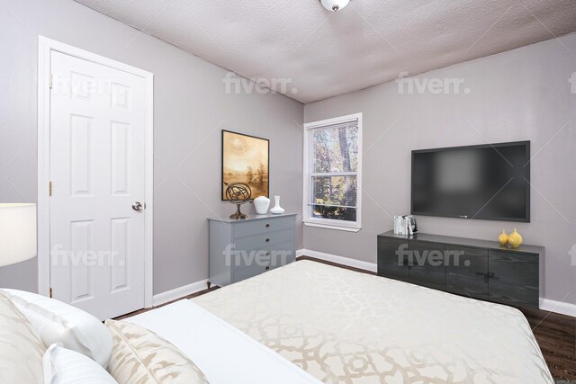 bedroom with a textured ceiling and dark wood-type flooring