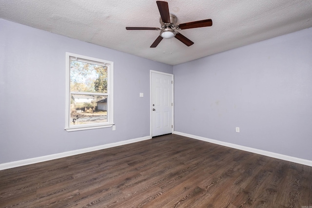 spare room with dark hardwood / wood-style floors, ceiling fan, and a textured ceiling