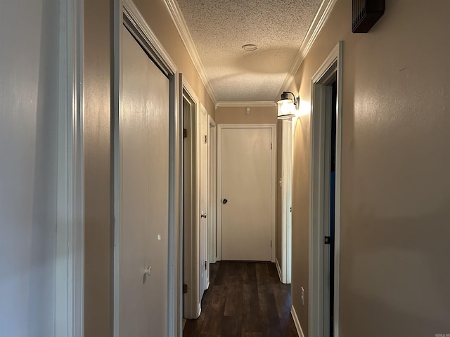 hall featuring a textured ceiling, dark hardwood / wood-style flooring, and crown molding