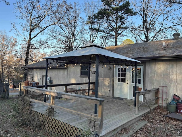 wooden terrace featuring a gazebo