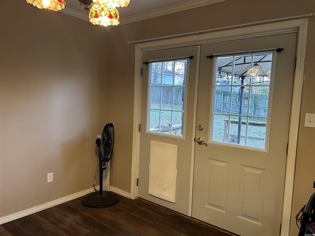 doorway featuring french doors, ornamental molding, and dark wood-type flooring