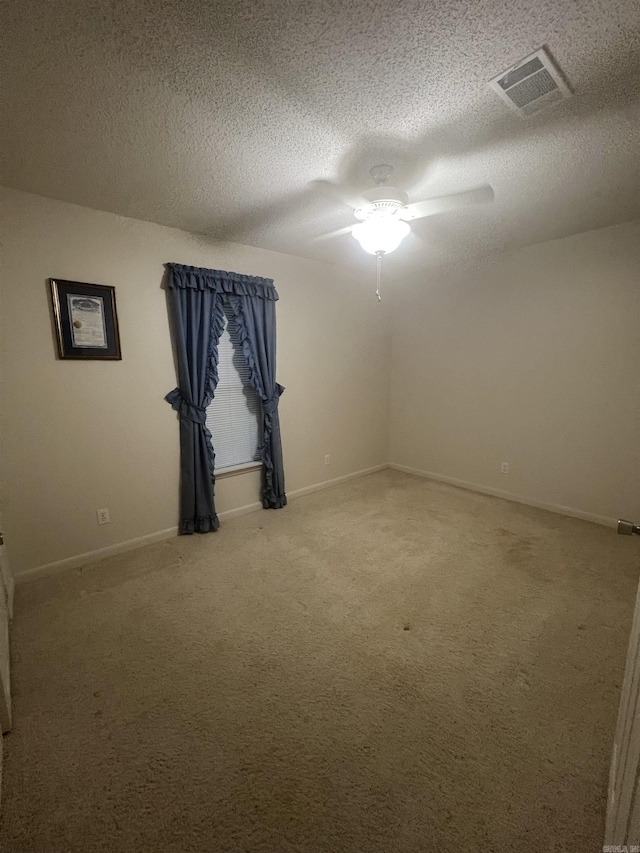 unfurnished room with carpet floors and a textured ceiling