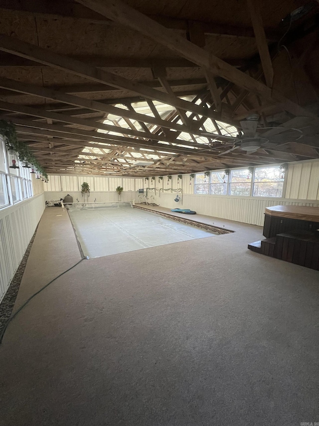 misc room with carpet floors and vaulted ceiling