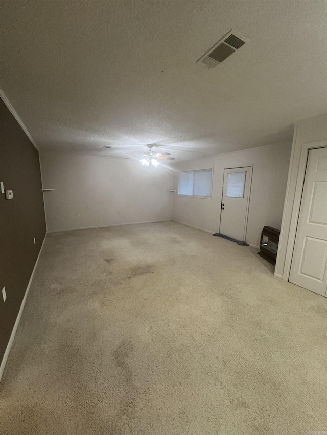 interior space with light carpet and a textured ceiling