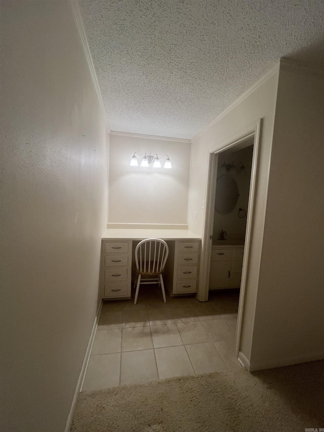 bathroom with tile patterned floors, a textured ceiling, and ornamental molding