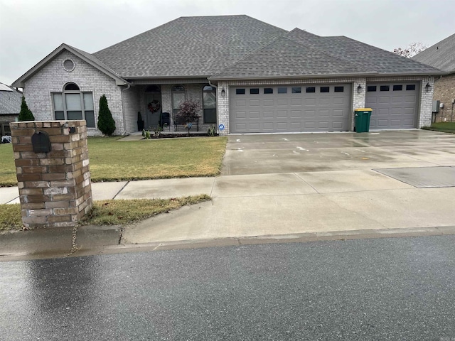 view of front facade featuring a front lawn and a garage