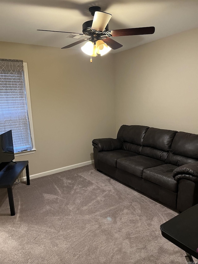 carpeted living room with ceiling fan