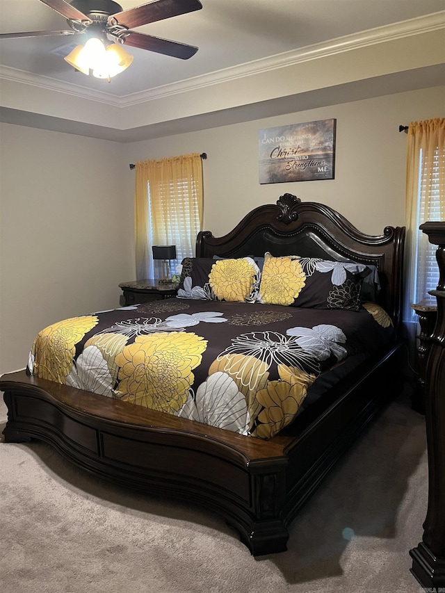 carpeted bedroom featuring ceiling fan and ornamental molding