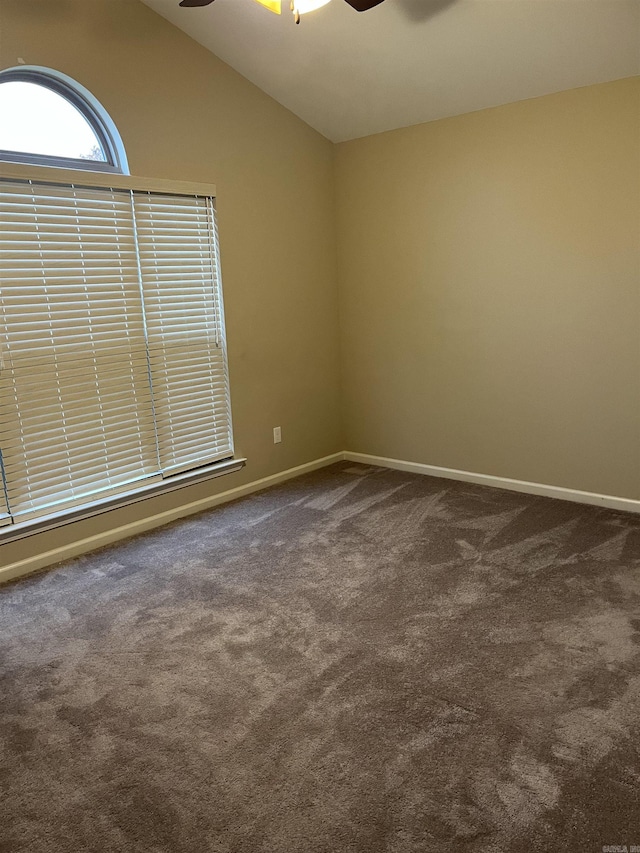 carpeted spare room with ceiling fan and lofted ceiling