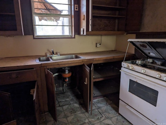 kitchen with dark brown cabinets, sink, and gas range gas stove