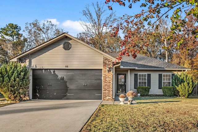 ranch-style home with a front lawn and a garage