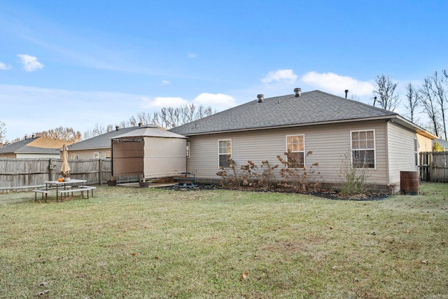 back of house featuring a yard