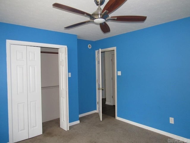 unfurnished bedroom featuring ceiling fan, a closet, and carpet